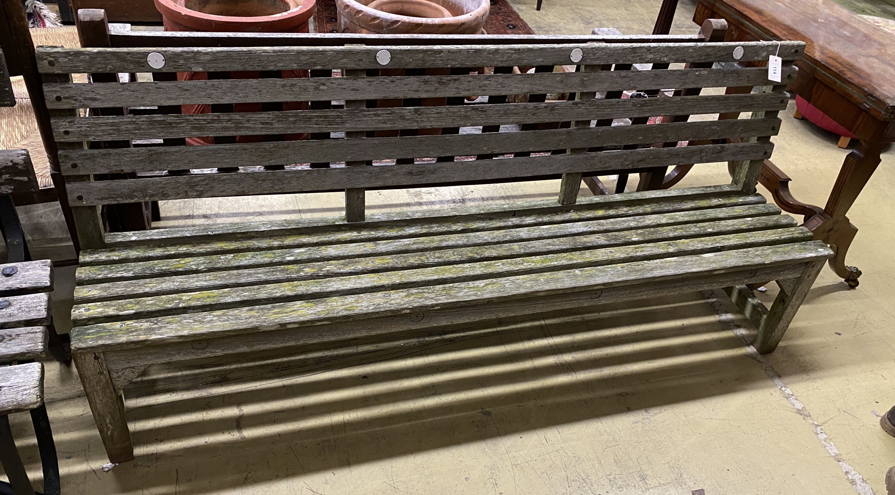 A weathered teak garden bench, length 183cm, depth 39cm, height 80cm